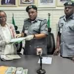 An official of EFCC, Mrs Amachree Ibinabi; Customs Area Controller, Muritala International Airport command, Comptroller, Effiong Harrison, and the Deputy Comptroller of Customs Anti Money Laundering and Countering, Mas’ud Salihu, during the handover of $29,000 due to false declaration